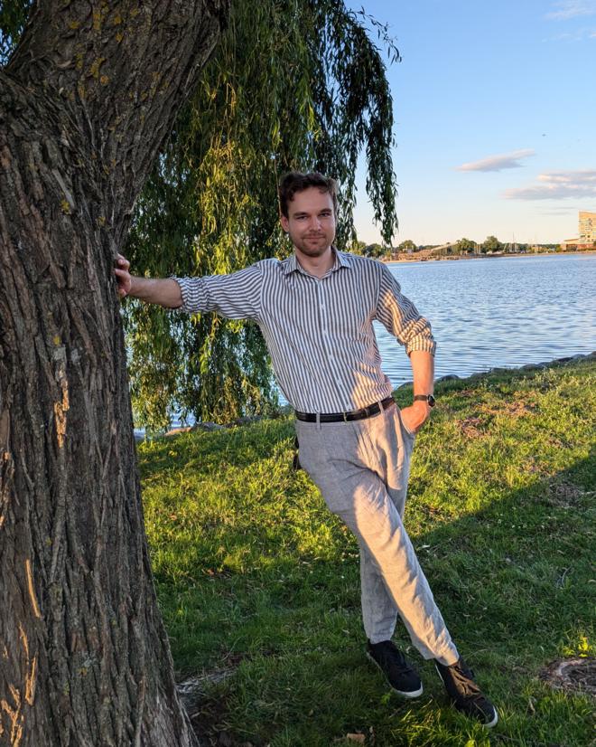 Johan, leaned against a large tree